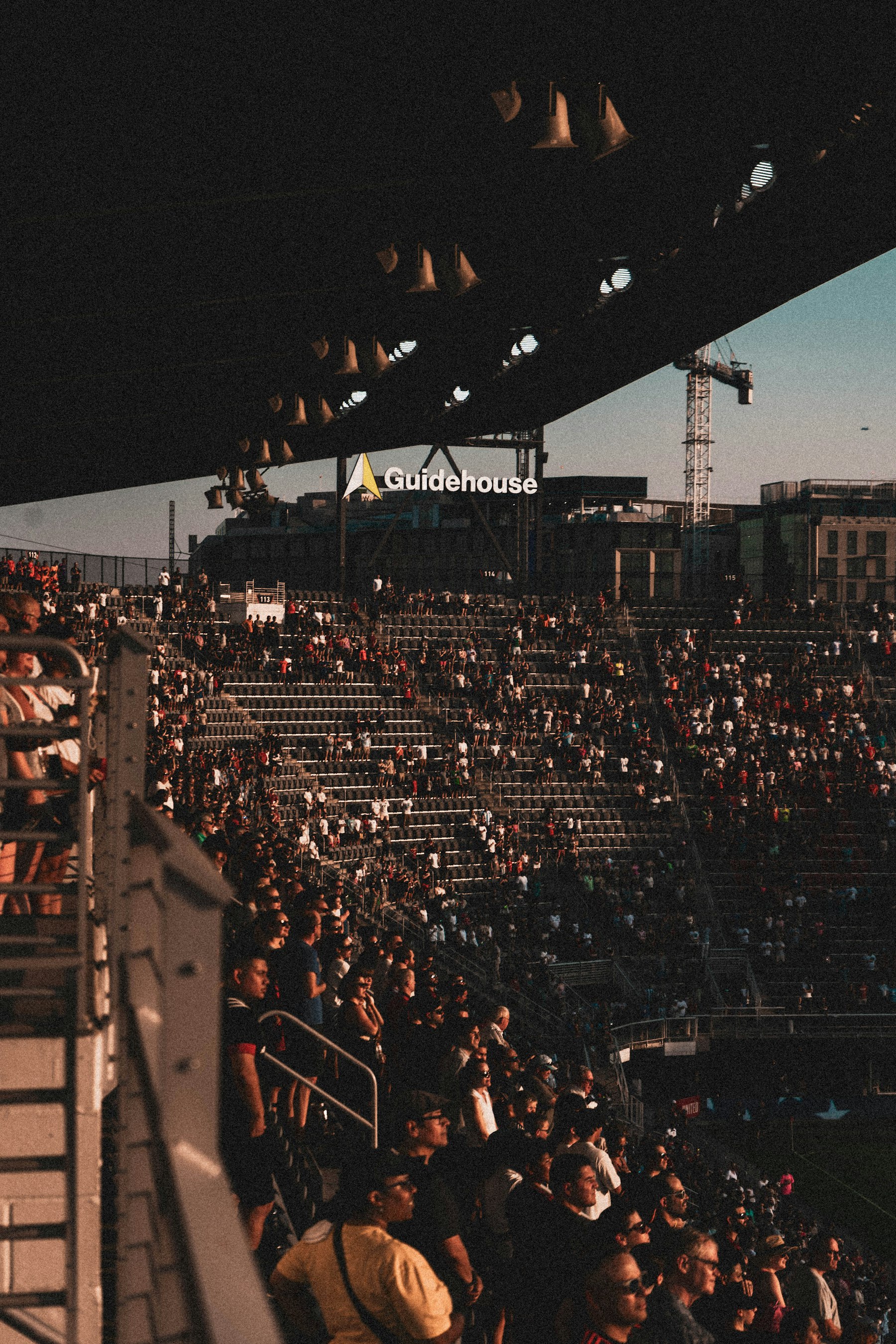 American football runner breaking forward under stadium lights
